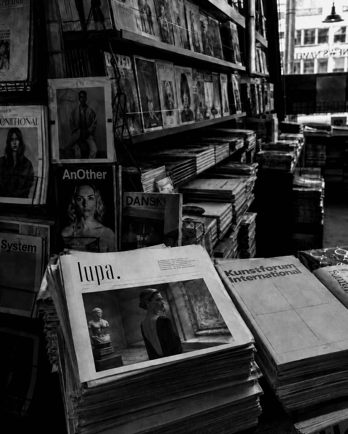 lupa. on a newsstand, alongside AnOther, System, DANSK, and Kunstforum International.